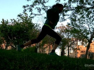 Doing lunges in a public park at sunset, voyeur clip from the grass