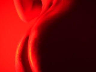 Solo nude girl in oil dancing in red light to the Weeknd music