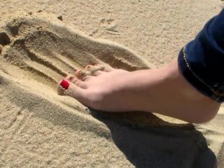 Red Toe Nails in the Beach Sand