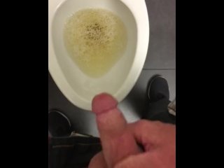 POV pissing into a toilet in a public bathroom and jerking off and cumming