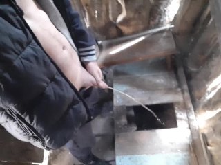 Russian guy pisses in a rustic toilet