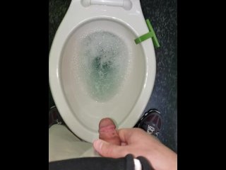 pissing in a clean spotless toilet with blue cleaner at work