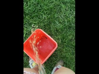 Girl Pees Outside In Orange Bucket