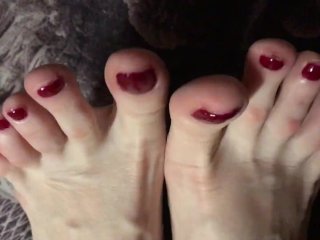 Red painted toenails close up