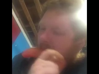 Fat guy sucking on dildo