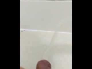 Pissing in the shower wall