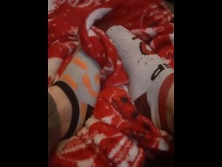 Tiny feet in mix match socks rubbing blanket