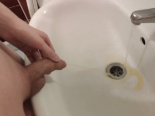 Gay with a shaved cock pissing in the sink