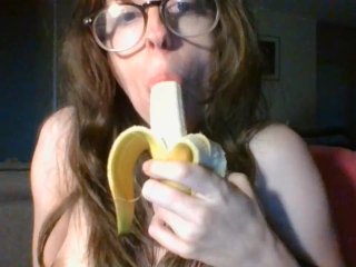 girl with cute glasses sucks banana