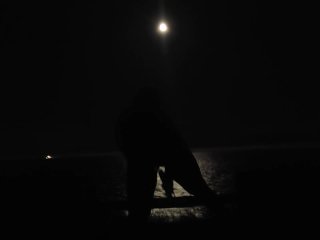 Woman dildo fucks pussy in moonlight by the ocean