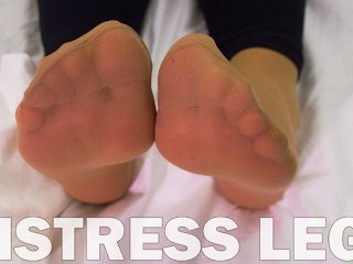 Foot fetish Goddess feet in soft nylon socks is resting on the bed