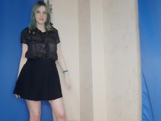 A girl in a skirt dances and masturbates with clamps on the nipples