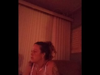 Milf with big boobs showing off cleavage while playing video games and smoking at same time