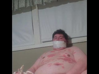 Fat male gagged with hand taped to leg masturbating