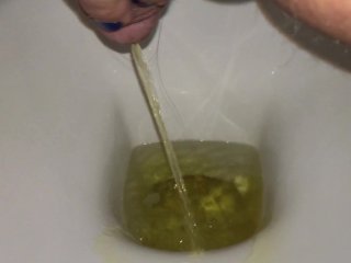 Urination into the toilet with yellow urine