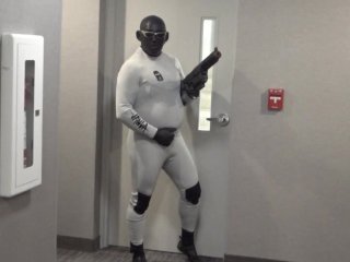 horny wetsuited armed guard patrolling hotel hall