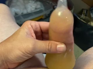 Stroking in pee filled condom