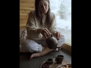 A girl filling tea into a classic cup