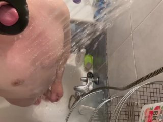 A hairy man takes a shower and jerks off his big humped cock