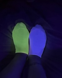 mismatched socks glowing in blacklight photo