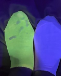 mismatched socks glowing in blacklight photo