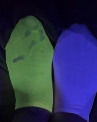 mismatched socks glowing in blacklight photo