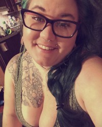 Sexy Tattooed BBW loving on some tasty cock photo
