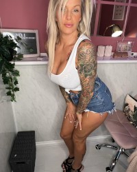 Tattooed Blond With Big Fake Tits Gets Them Out photo