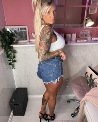Tattooed Blond With Big Fake Tits Gets Them Out photo