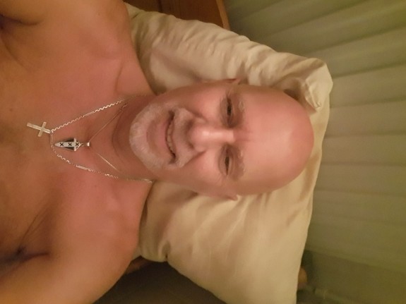 Nude in bed.