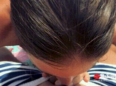 Wife with wedding ring giving blowjob on the nudist beach gif