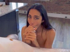 Brunette babe maintains eye contact whilst giving exceptional blowjob gif