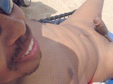 Angel-eyed demon sits with a throbbing cock on a public beach 0012-1 3 gif