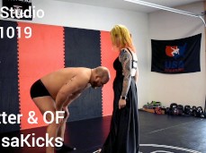 Woman in elegant  dress knees guy in the nuts gif