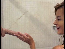 MILF with a perfect body takes a shower and gives a blowjob to a big dildo gif