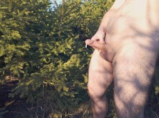 Beefy, hairy-legged man strokes his big, uncut cock and cums a lot outdoors gif
