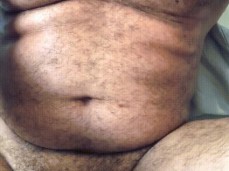 Beefy, hairy, uncut dude lets his big, heavy cockhead rest on his ankle gif