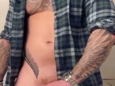 Buff, blonde, bearded, inked hunk strokes his massive uncut cock, cums hard gif