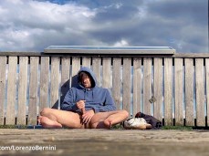 Sexy Lorenzo Bernini sits outside in a hoodie, stroking his big uncut cock gif