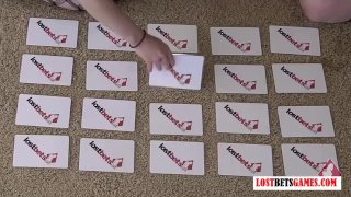 Two Girls Engage In A Card-Matching Strip Game