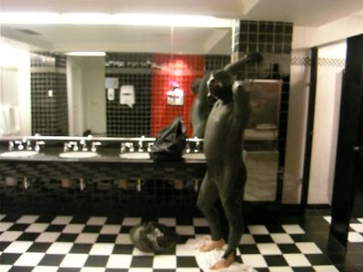 Thief changes into fully lubed rubber gear in public washroom