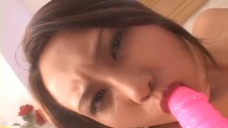 Sweet Japanese babe fucks herself with a thick dildo
