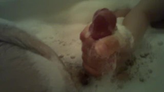 Big-Titted Hottie Performs A Handjob While Taking A Bubble Bath