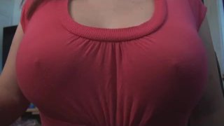 Show Off Her Breasts While Wearing A Cute Pink Shirt
