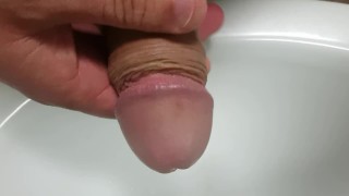 Pissing into my foreskin before massaging my glans to orgasm