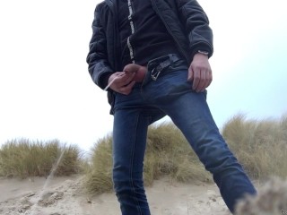 Young Man Urinates in the Dunes