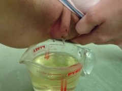 pee in measuring cup | close up
