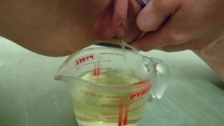 pee in measuring cup | close up
