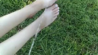 Pissing on girlfriends feet outdoors
