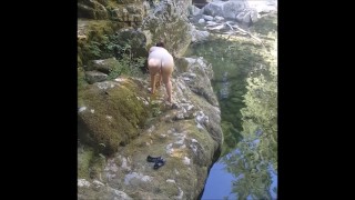 MILF flashing and masturbating by the river